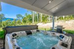 Hot tub under carport with mountain views